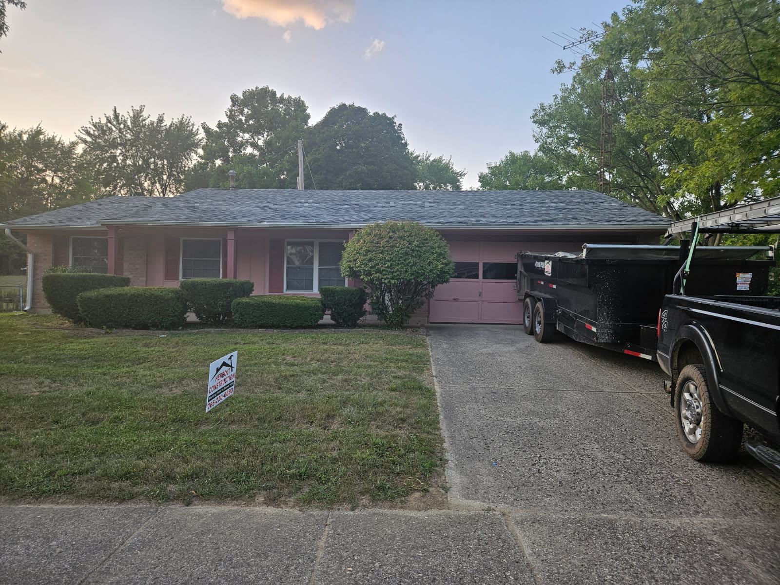 Ranch Home Roof Replacement — Tear-off day — crew, dump trailer, and a clean job site.