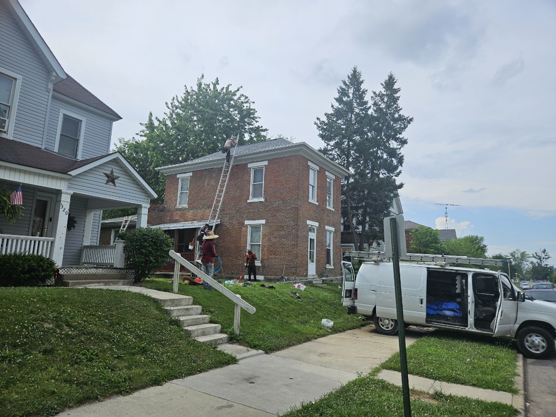 Two-Story Brick Home — Roof and gutter work on a historic two-story brick home.